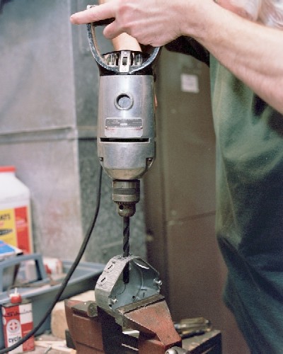 Enlarging the intake port with large, slow drill (c) 2004 Larry Cottrill