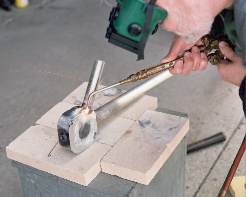 Tack welding the cover plate to the left side of the combustion chamber (c) 2004 Larry Cottrill