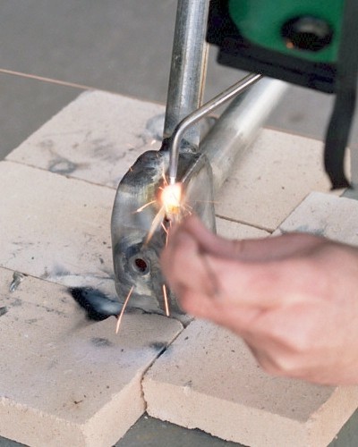 Finish welding the comustion chamber, adding filler metal only at the corner voids (c) 2004 Larry Cottrill