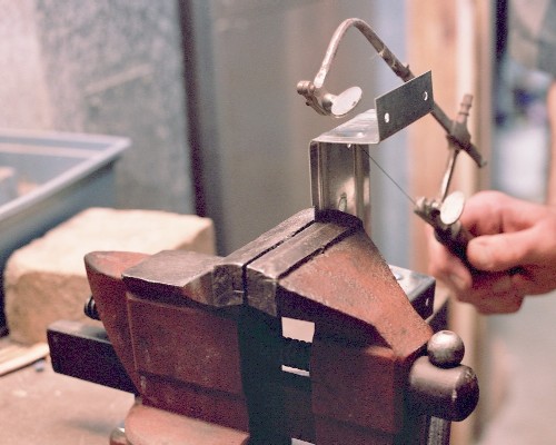 Cutting engine mounts from 'fence rail bracket' hardware (c) 2004 Larry Cottrill