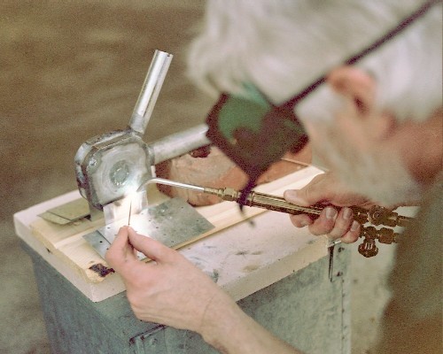 Tack welding the engine mounts to the combustion chamber (c) 2004 Larry Cottrill