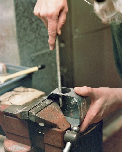 Enlarging the exhaust port with large round file (c) 2004 Larry Cottrill