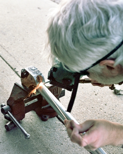 Making the first tack weld between the exhaust pipe and the chamber (c) 2004 Larry Cottrill