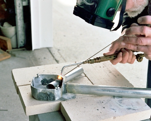 Tack welding the intake stack to the chamber (c) 2004 Larry Cottrill