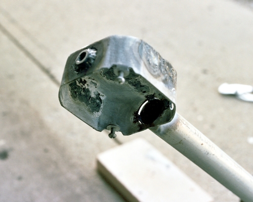 View of the tack welds joining the exhaust pipe to the chamber, before finishing the welded joint (c) 2004 Larry Cottrill