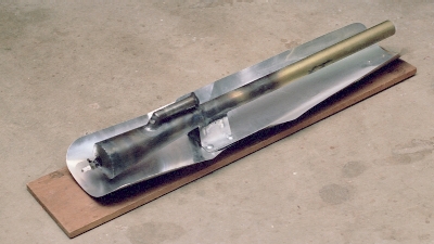 The engine mounted for testing on a simple wood plank mount, with sheet aluminum heat shielding in place (c) 2004 Larry Cottrill
