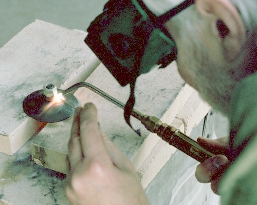 Welding the spark plug mount nut to the front dome (c) 2004 Larry Cottrill