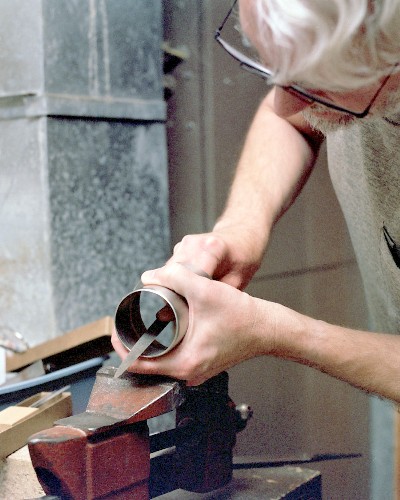 Final smoothing and streamlining of the inlet, using a fine half-round file (c) 2003 Larry Cottrill