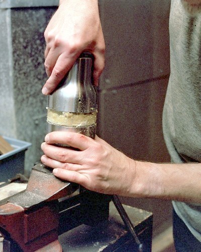 Pulling the fully cut diffuser section off the mug insulation, with some difficulty (c) 2003 Larry Cottrill