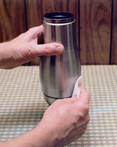 Wiping away excess epoxy after gluing the diffuser assembly into the combustor shell (c) 2003 Larry Cottrill