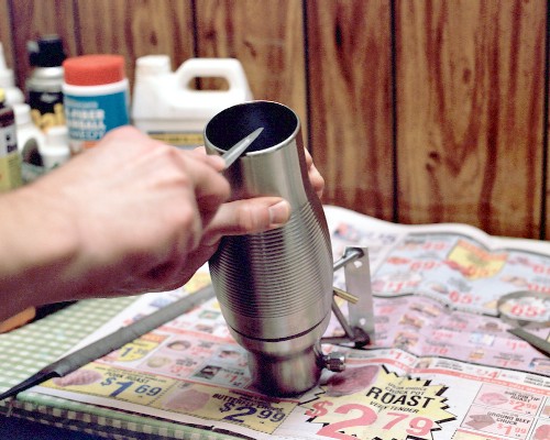 Finishing the exhaust port with a fine half-round file (c) 2003 Larry Cottrill