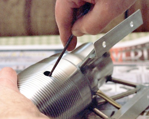 Filing out the spark plug mounting hole (c) 2003 Larry Cottrill