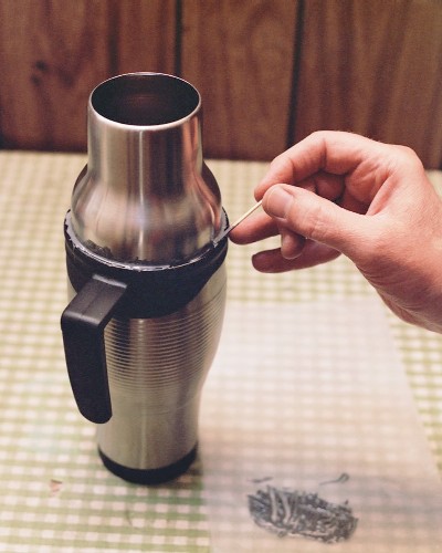 Using the plastic top of the Wal-Mart mug to form the epoxy ring at the rear of the diffuser shell (c) 2003 Larry Cottrill